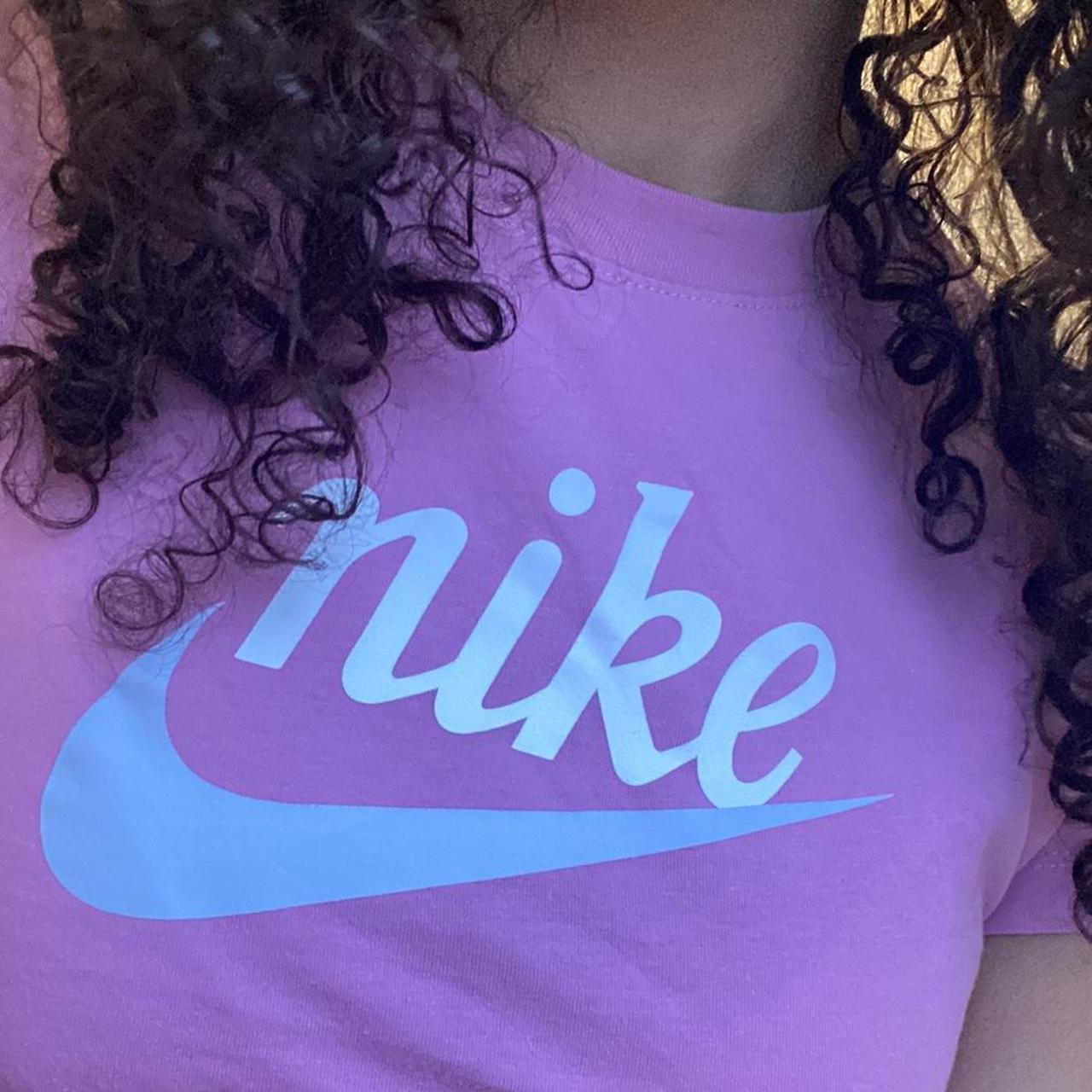 nike pink y2k style baby tee with blue swoosh and... - Depop