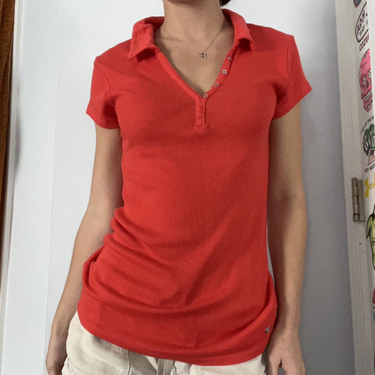 Red collared polo shirt with buttons down the