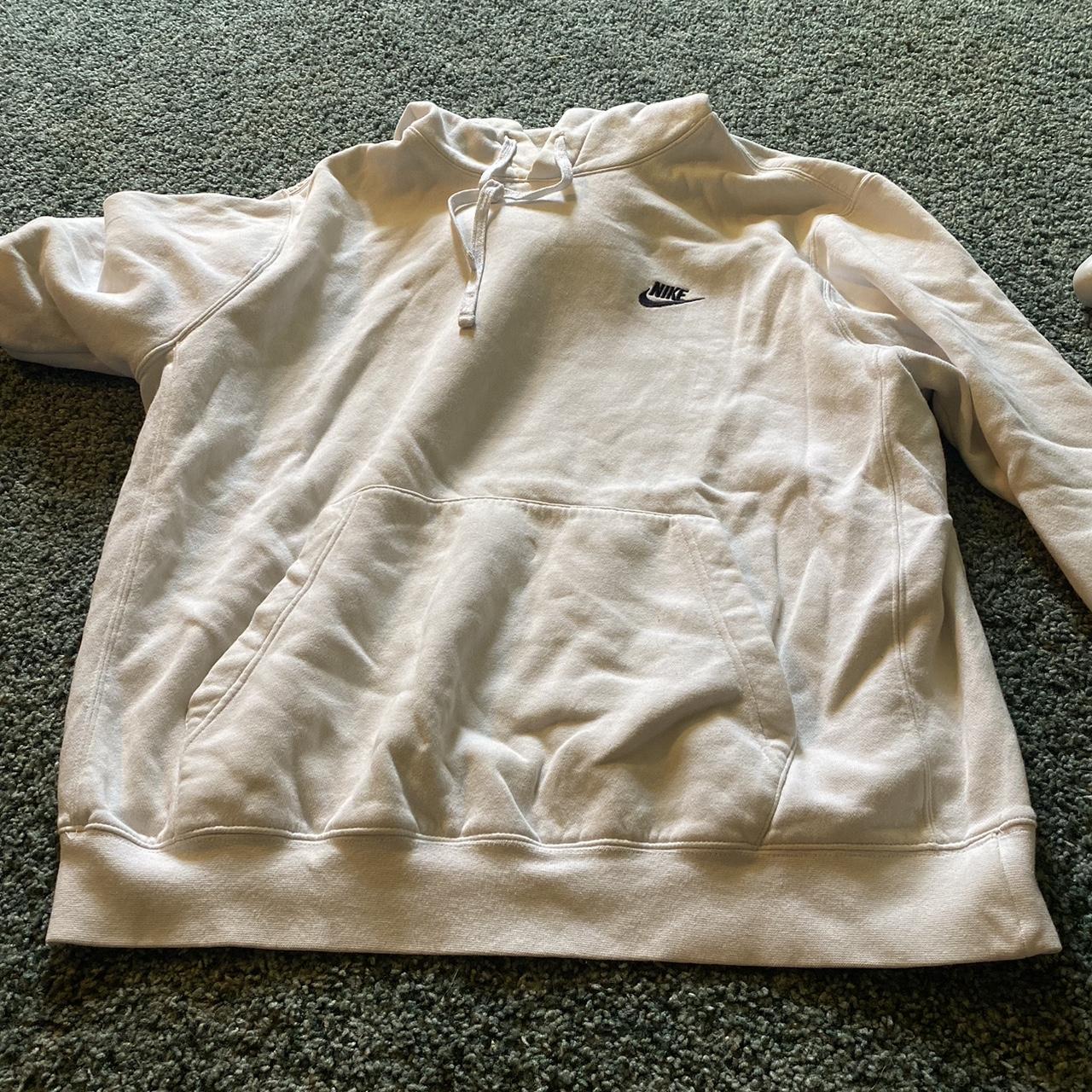 white nike hoodie with nike all over it