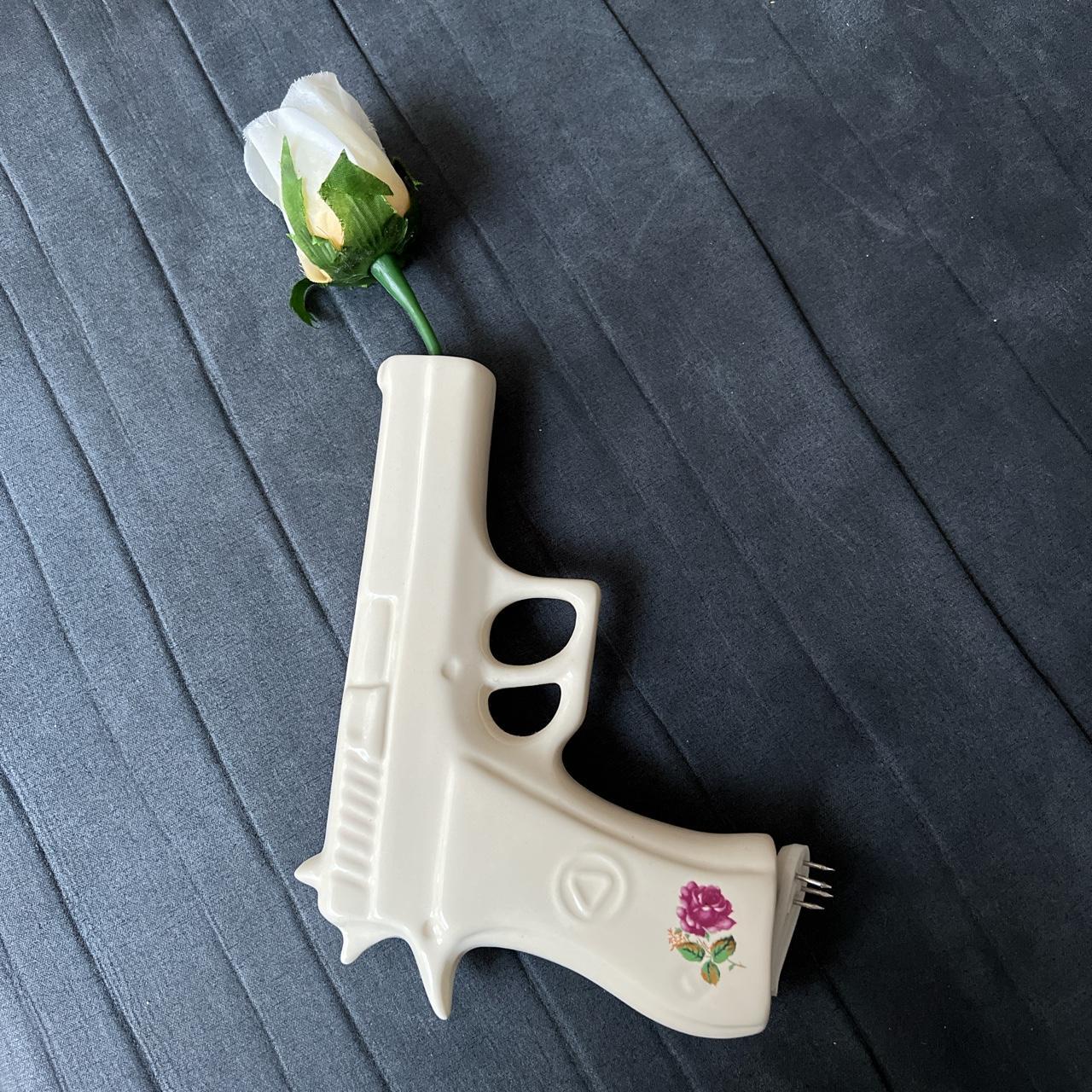 Ceramic gun wall art with rose flower attached. This... Depop