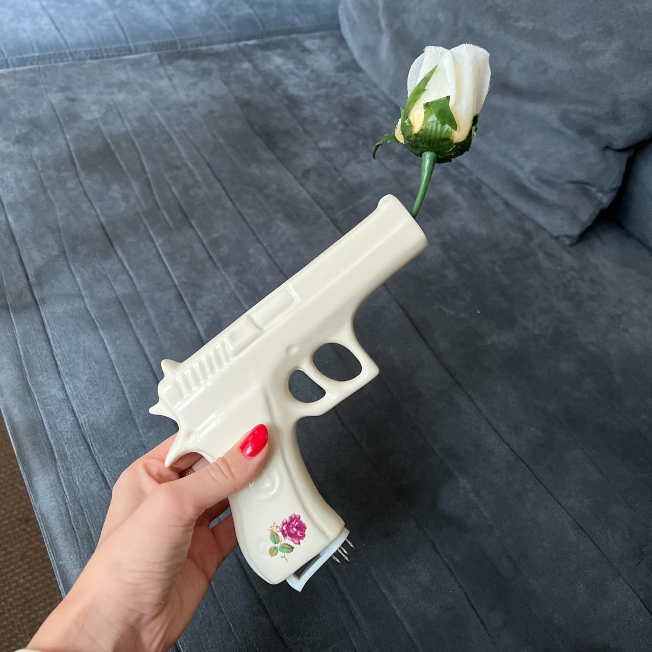 Ceramic gun wall art with rose flower attached. This... Depop