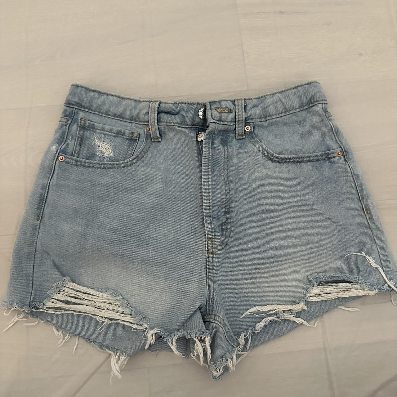 Blue denim shorts with rips in the back and front