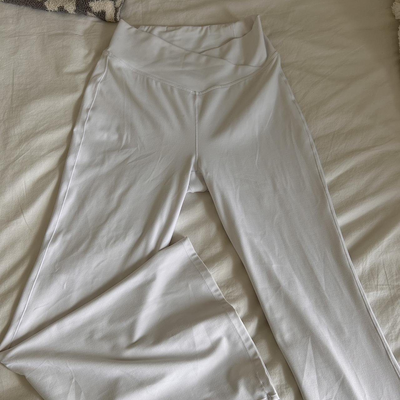 white asymmetrical flare pants brand is Halara size... - Depop