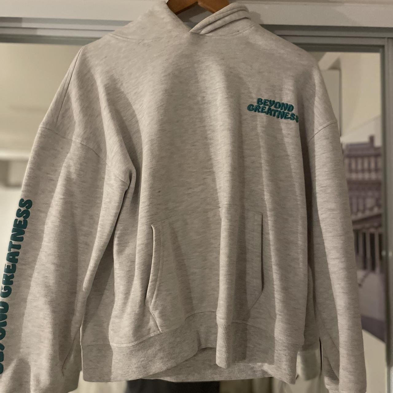 Grey hoodie with green writing sale