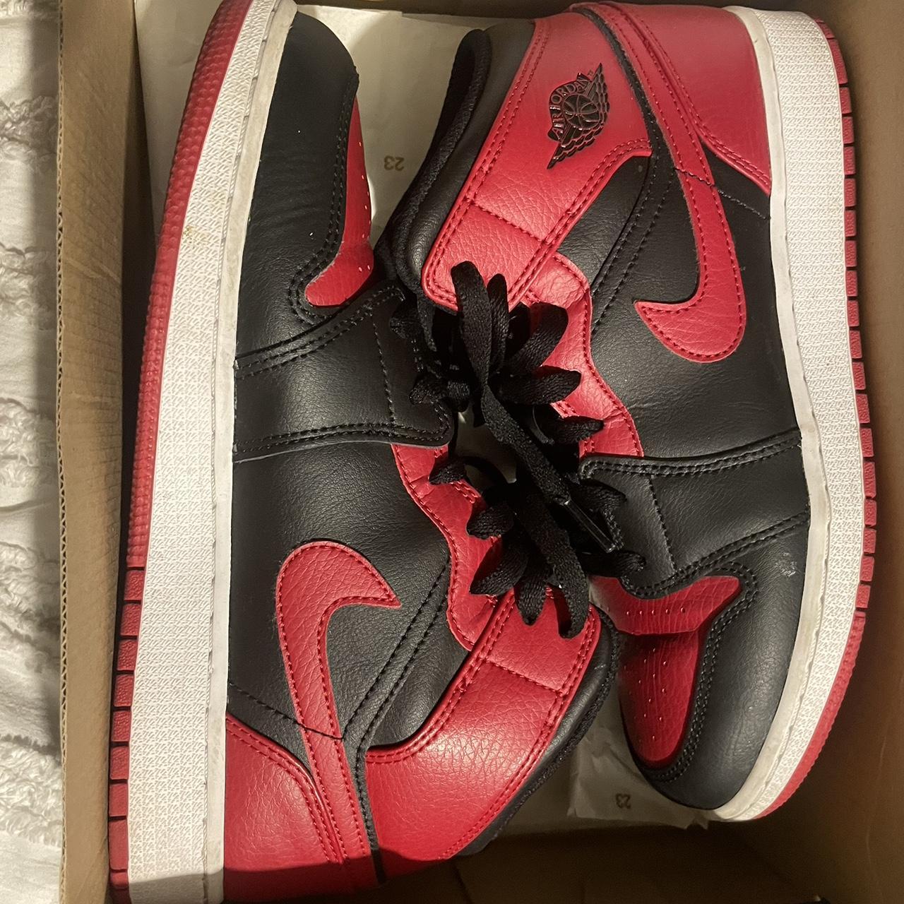 half black half red jordan ones