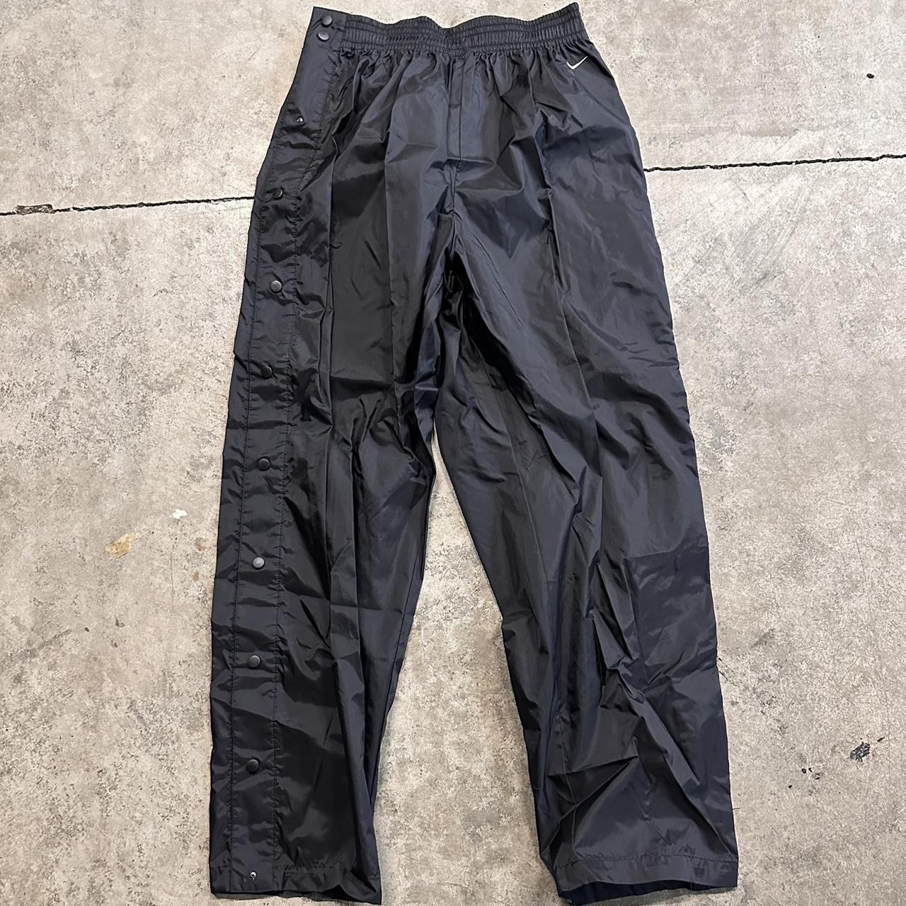 Nike track pants online side buttons