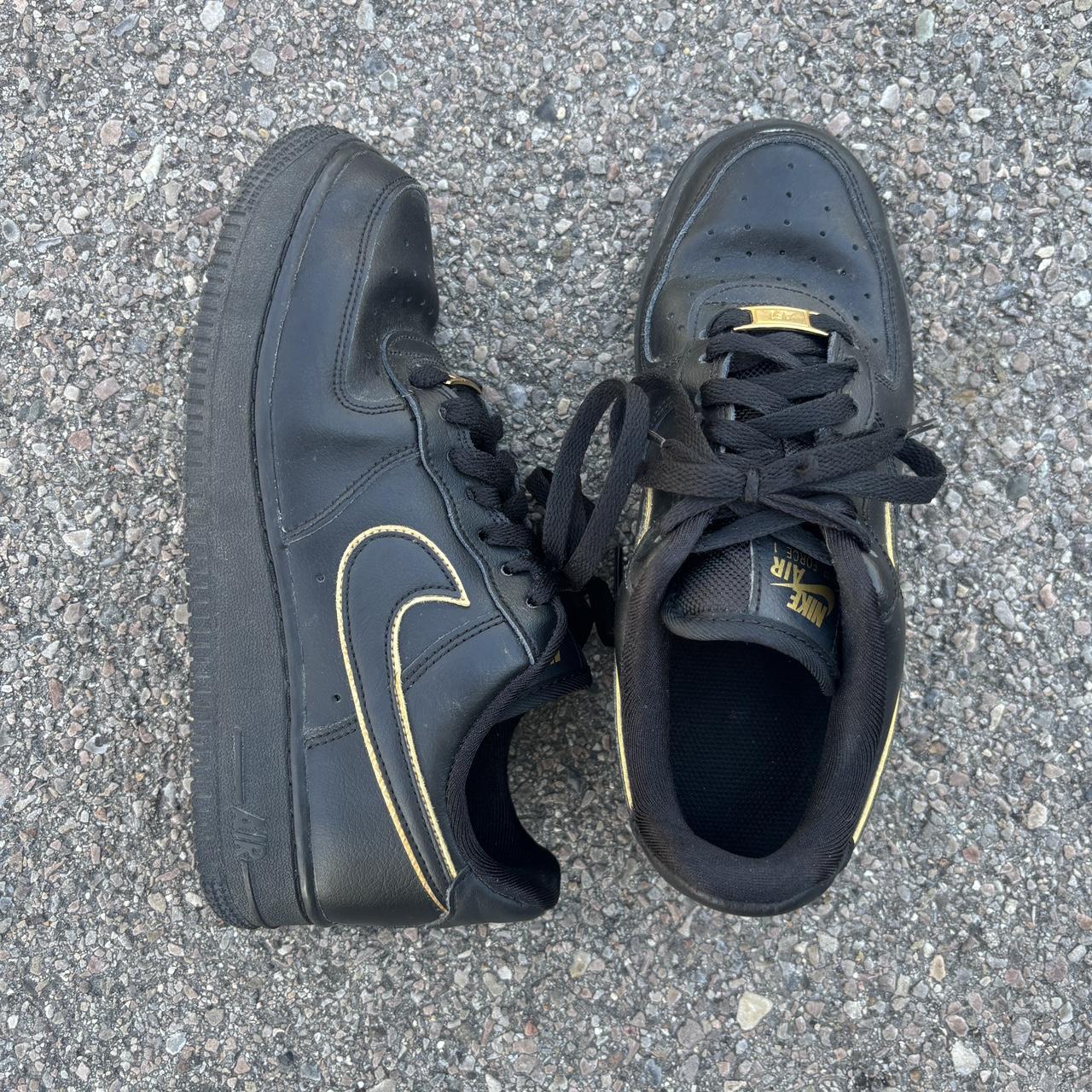 nike black shoes with gold swoosh