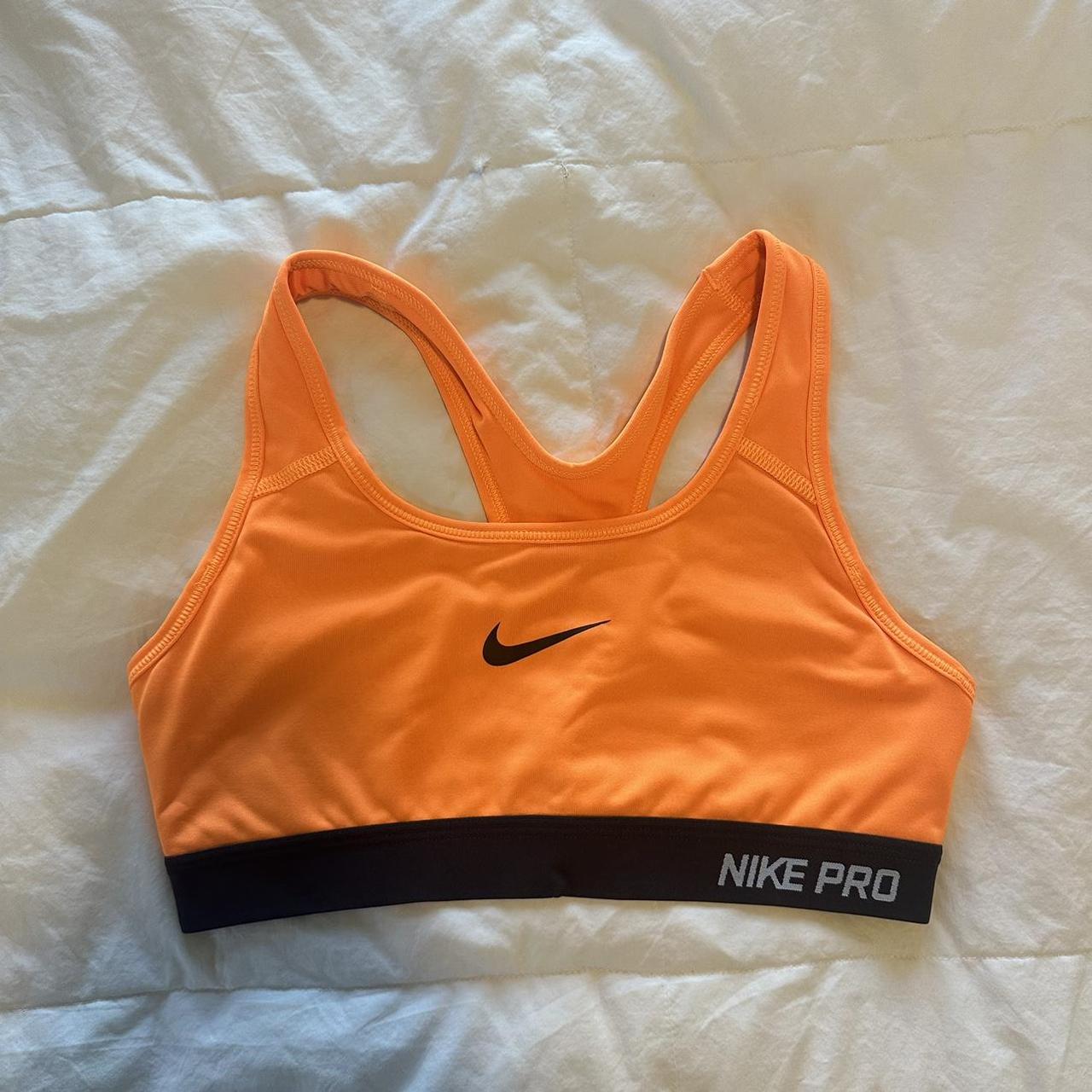 Neon orange Nike sports bra. No padding included but... - Depop