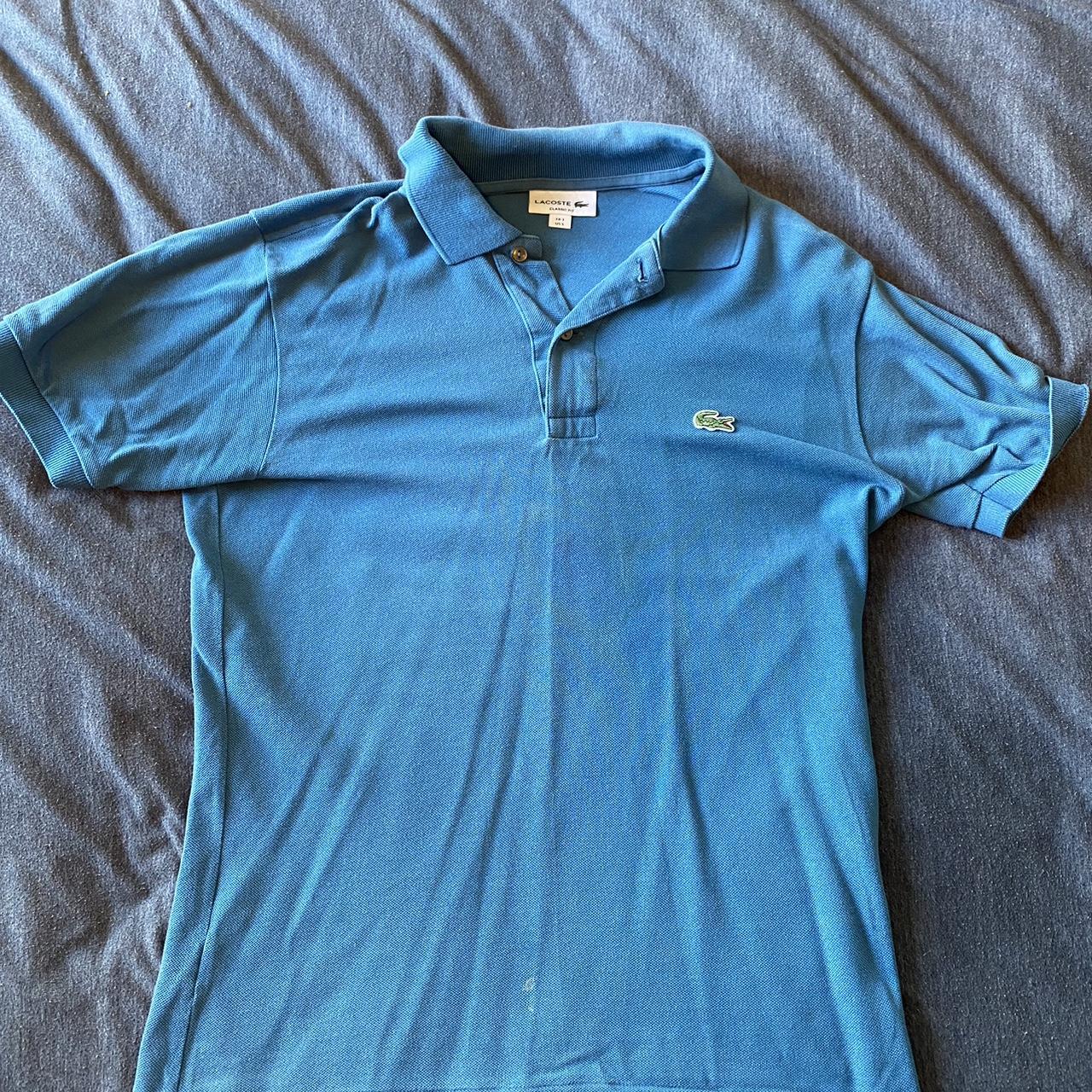 Blue Lacoste polo shirt in a size small. Small stain... - Depop