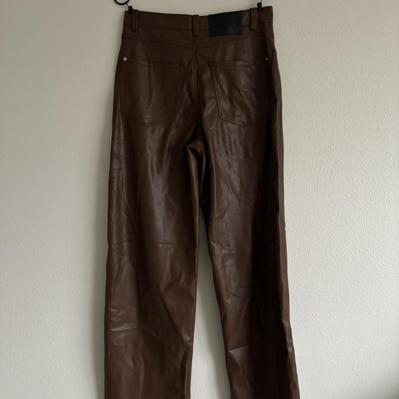 Brown faux leather pants with slits at the bottom of - Depop