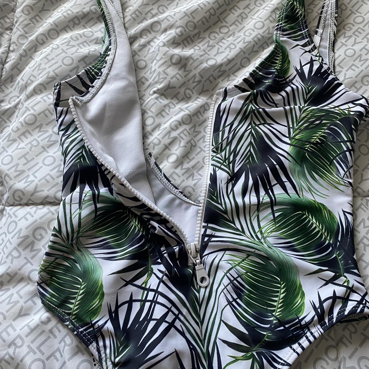 palm tree swimsuit zipper works and the cut is a... Depop