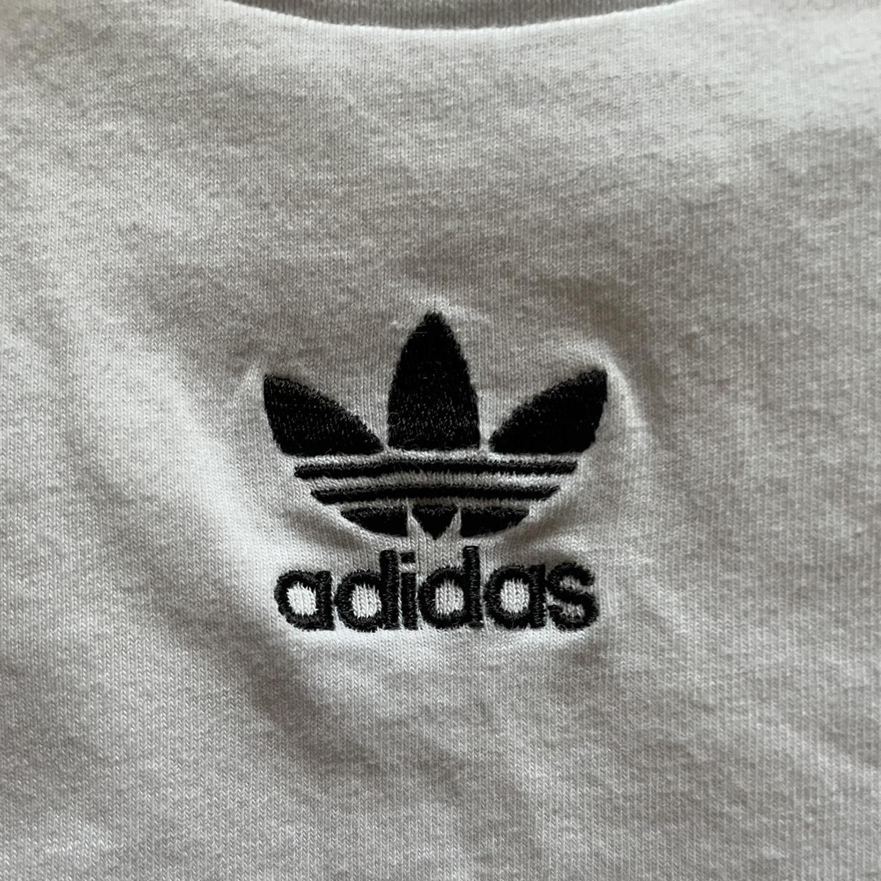 white adidas tank top has black strips on the side... - Depop