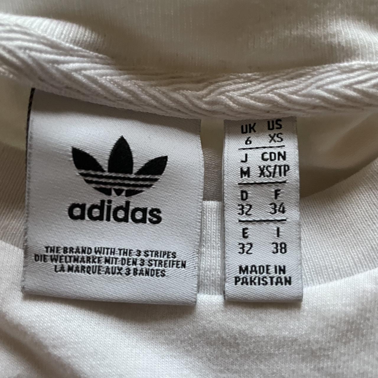 white adidas tank top has black strips on the side... - Depop