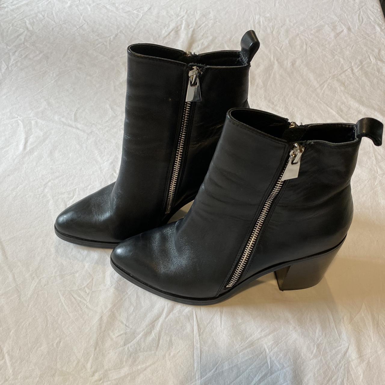 Black leather ankle boots with silver hardware has