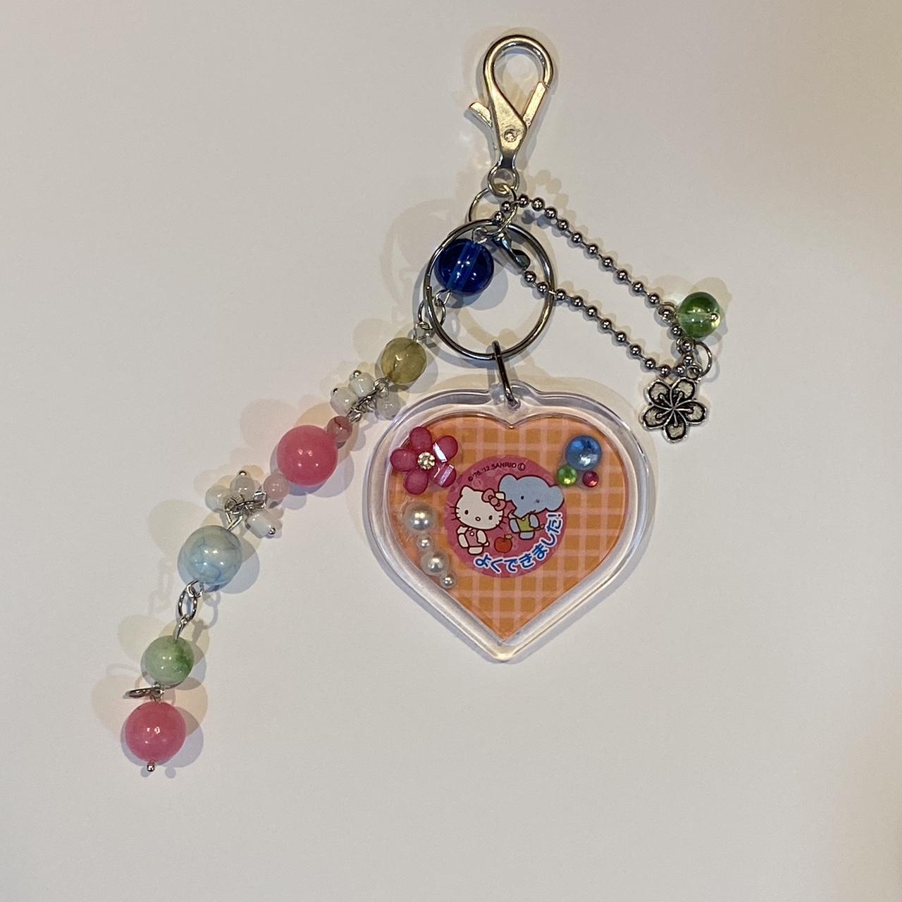 Hello kitty n elephant heart frame keychain... - Depop