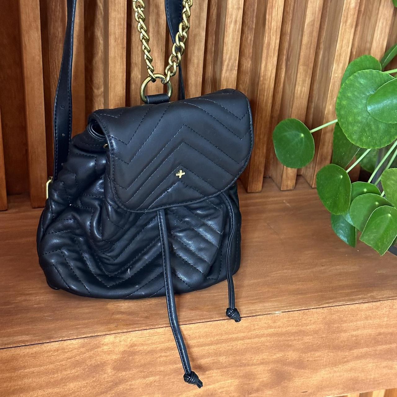 this mini black backpack with gold chain straps is