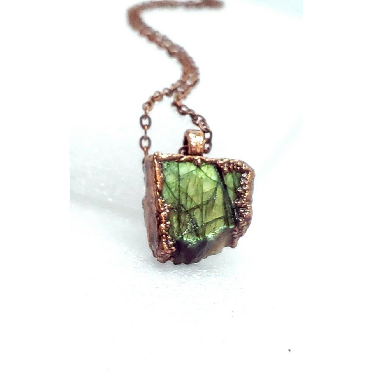 A bright green raw labradorite crystal that has been... - Depop
