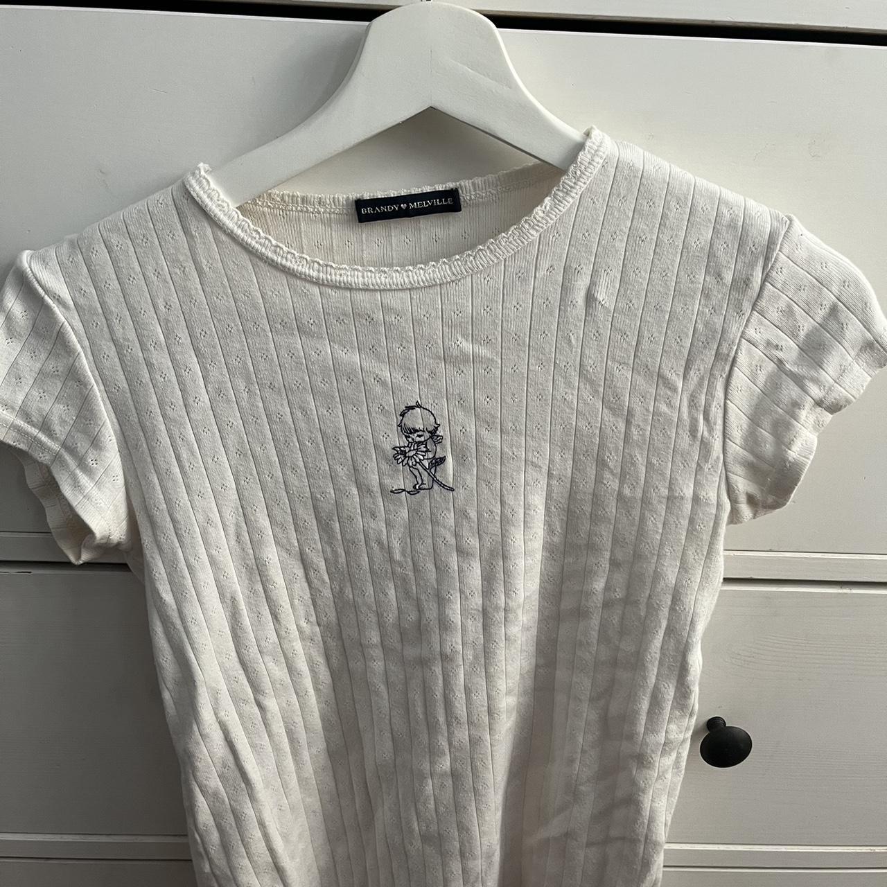 Brandy Melville white tee with an baby angel design... Depop