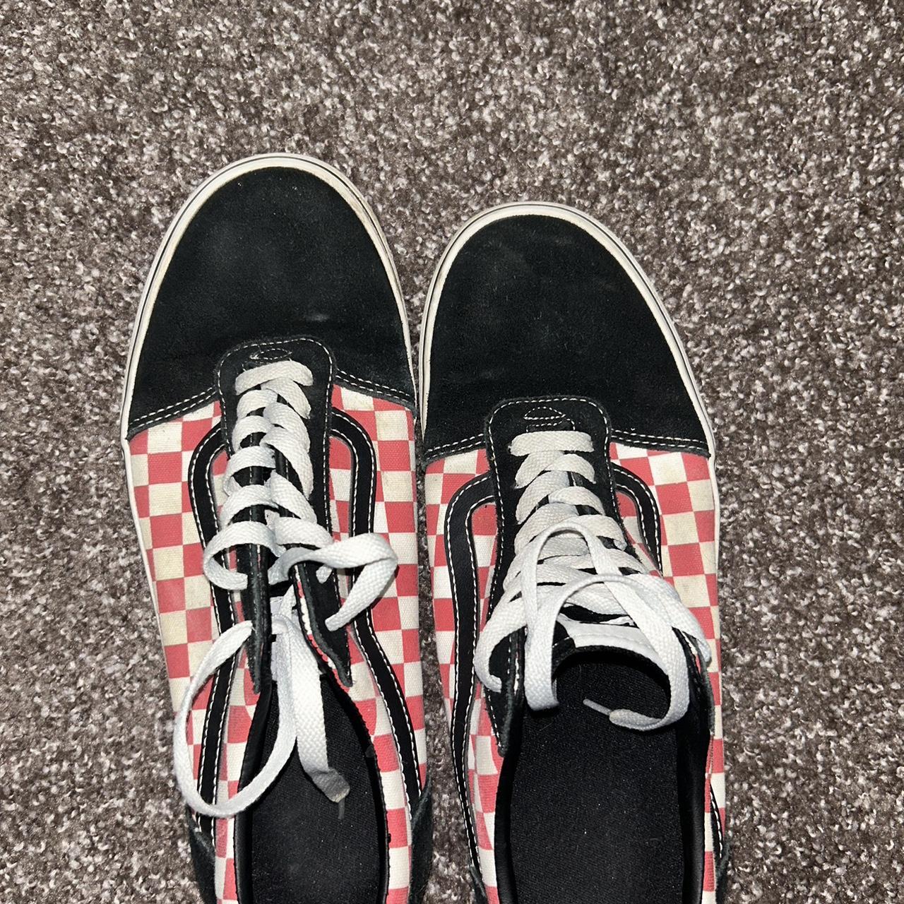 Red and black checker Vans. Some wear of the soles