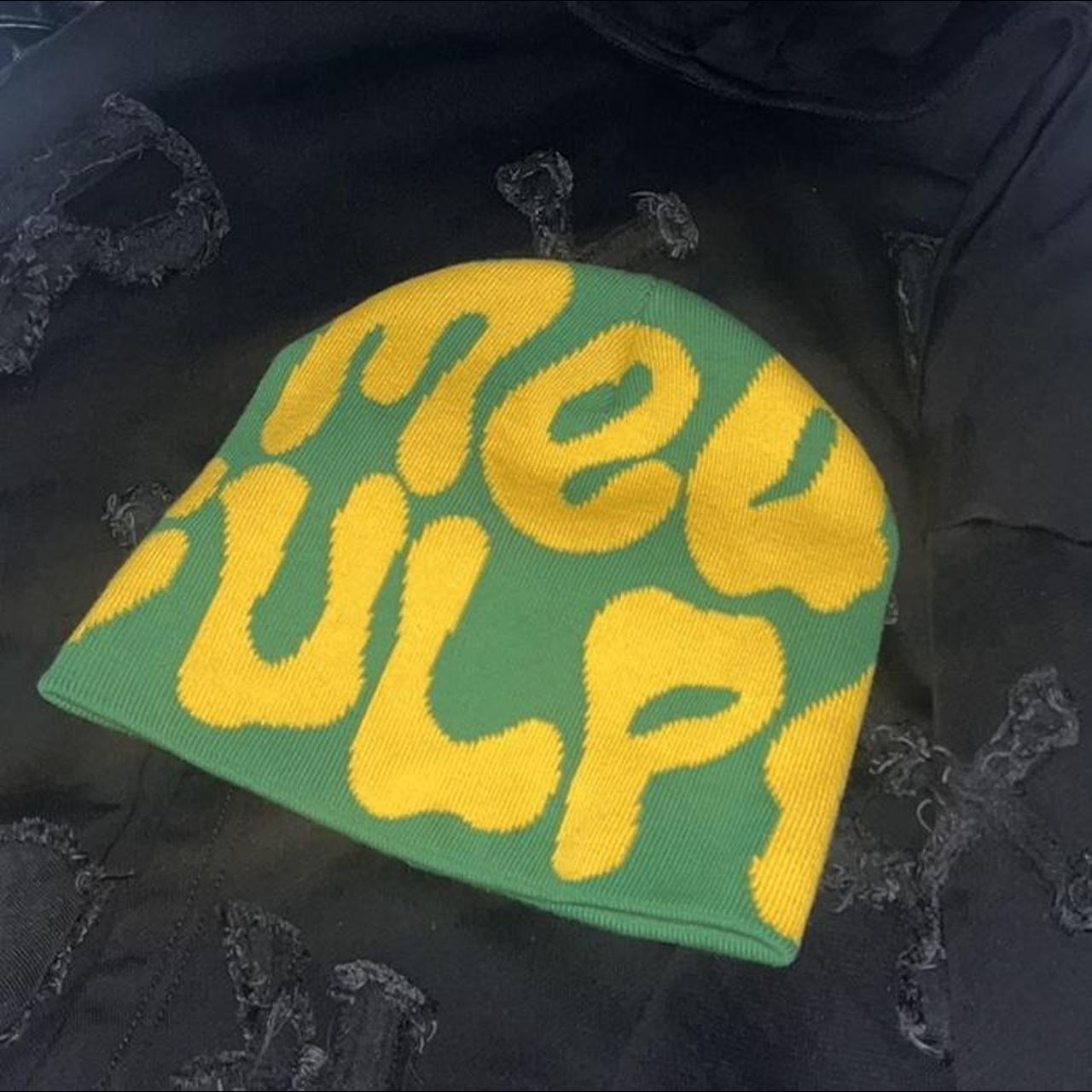 Green and Yellow Mea Culpa beanie. Has a rip at the... - Depop