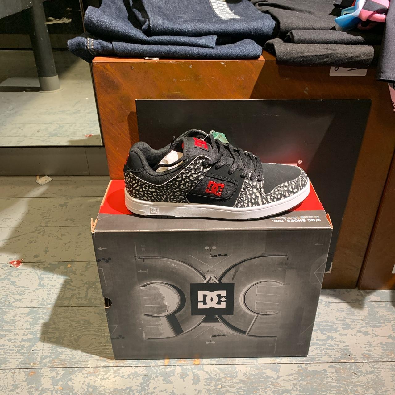 white and red dc shoes