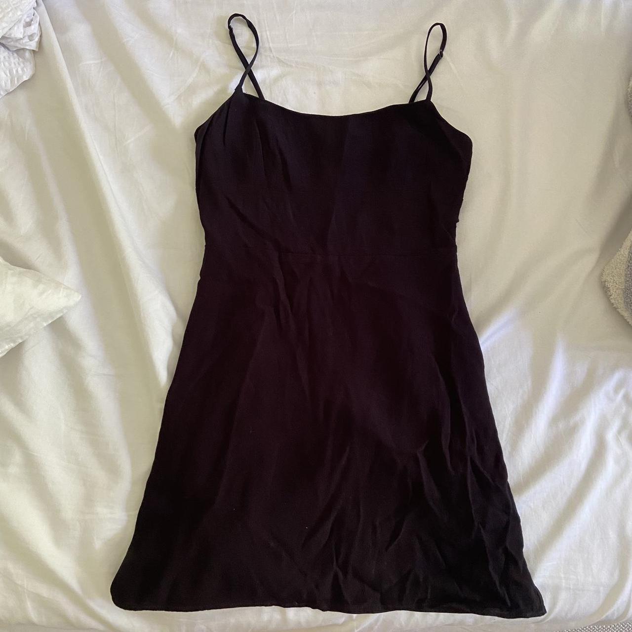 An Aritzia black mini dress with a black band... - Depop