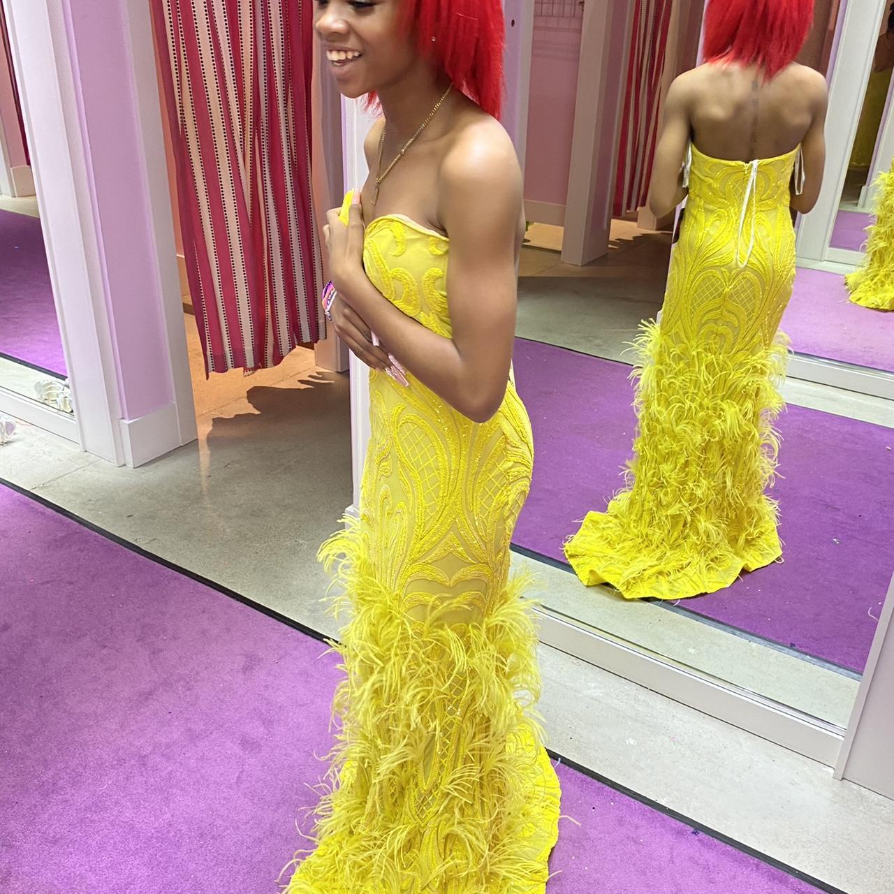 Yellow prom dress with feathers at the bottom. Had