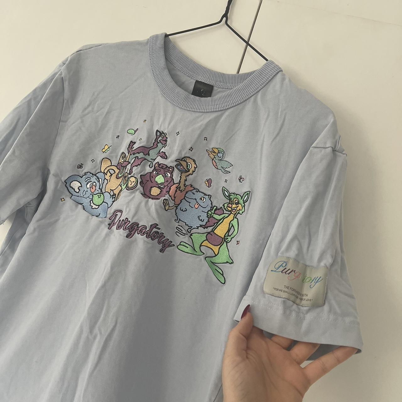 Baby blue tee shirt with embroidered cartoon... Depop