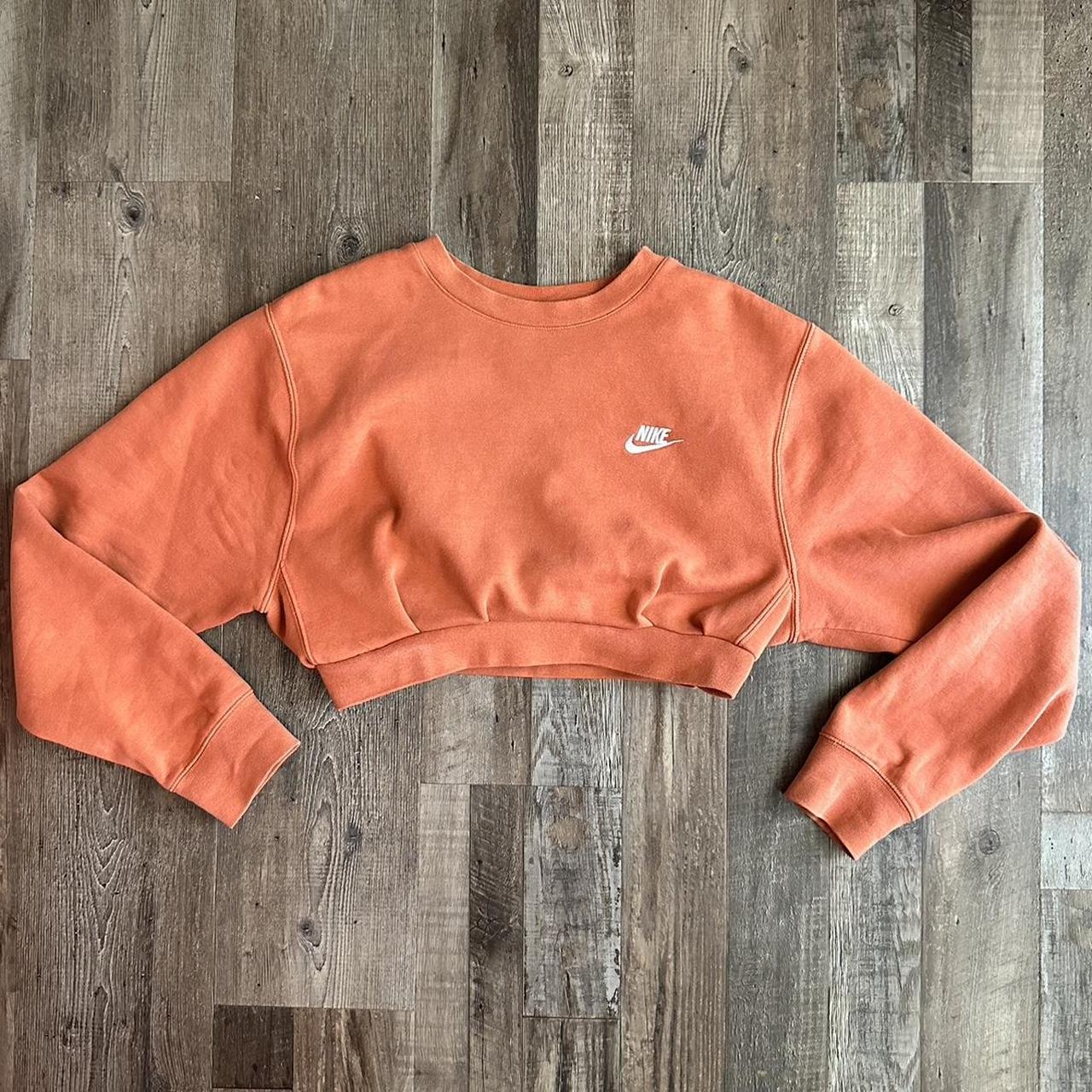 cropped burnt orange nike crewneck fits snugly at