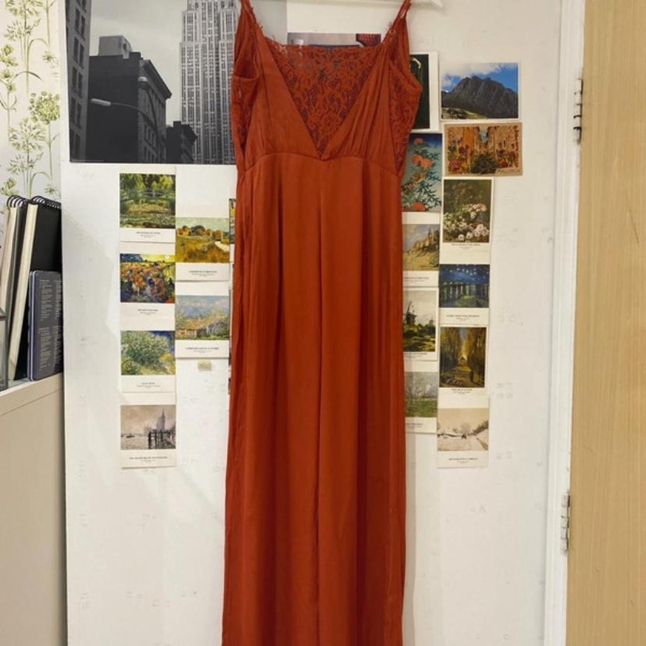 Burnt orange jumpsuit with lace detailing on