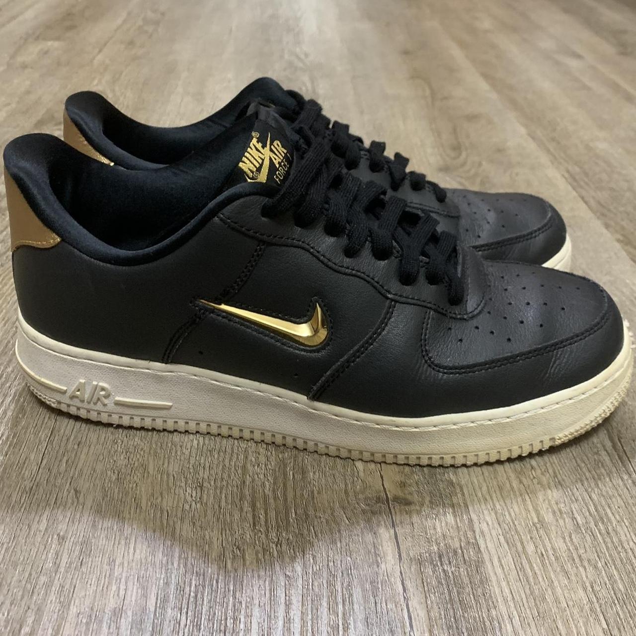 black nike sneakers with gold swoosh