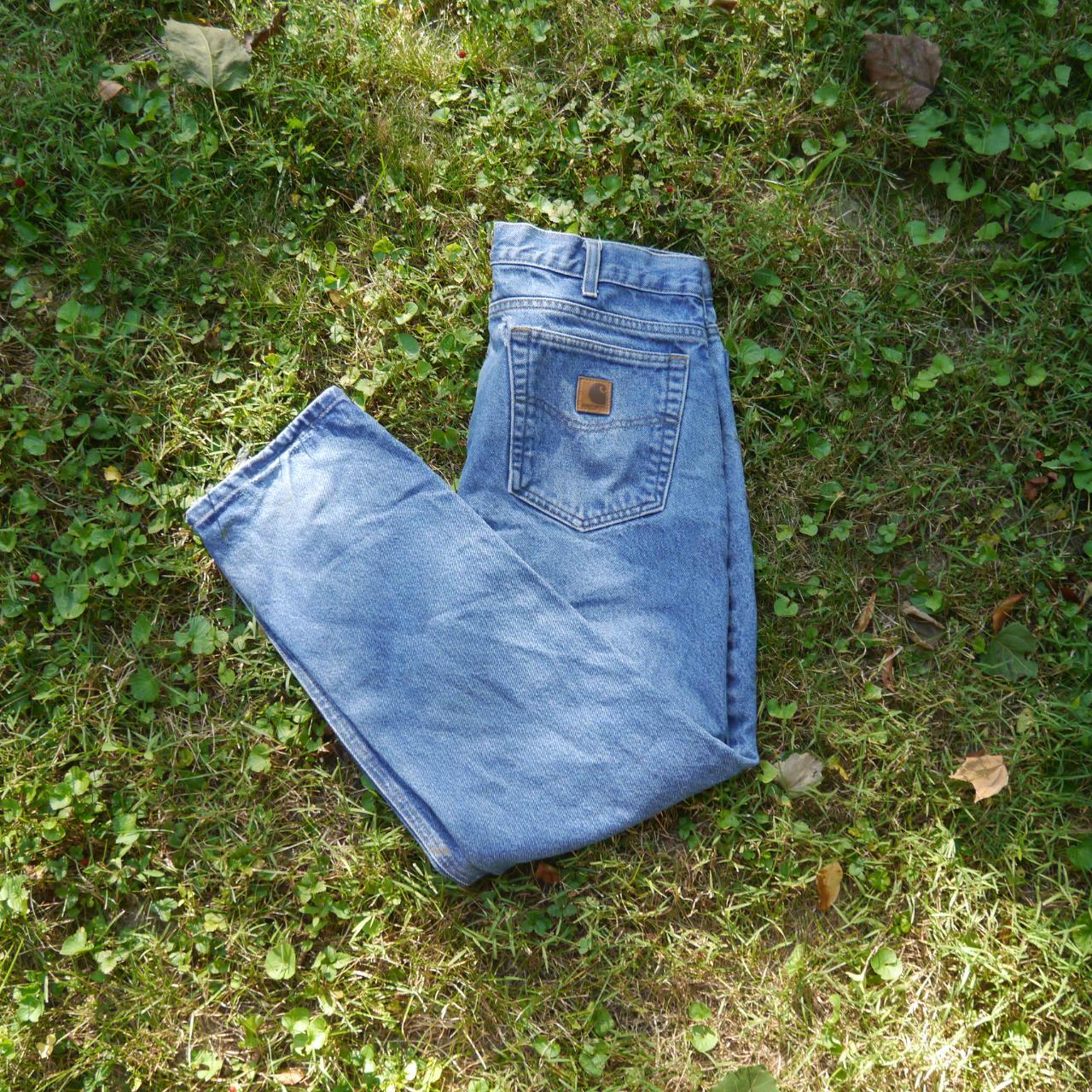 Carhartt Jeans Small rip on top left corner of back... - Depop