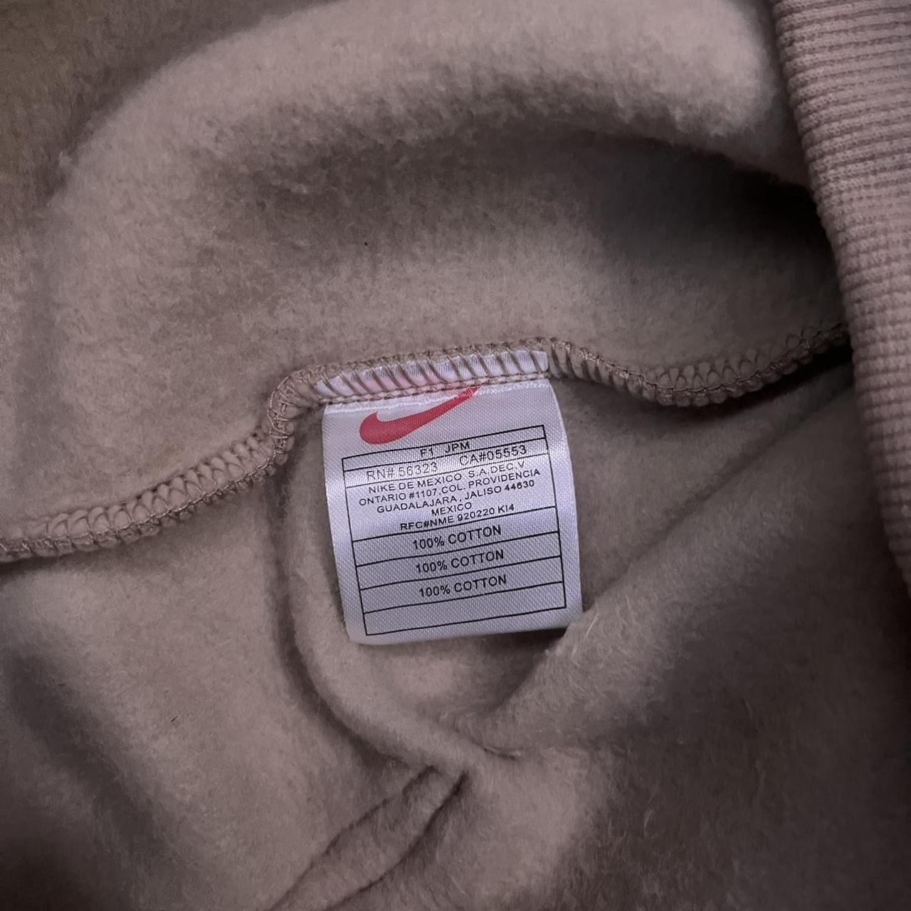 tan nike hoodie with black swoosh