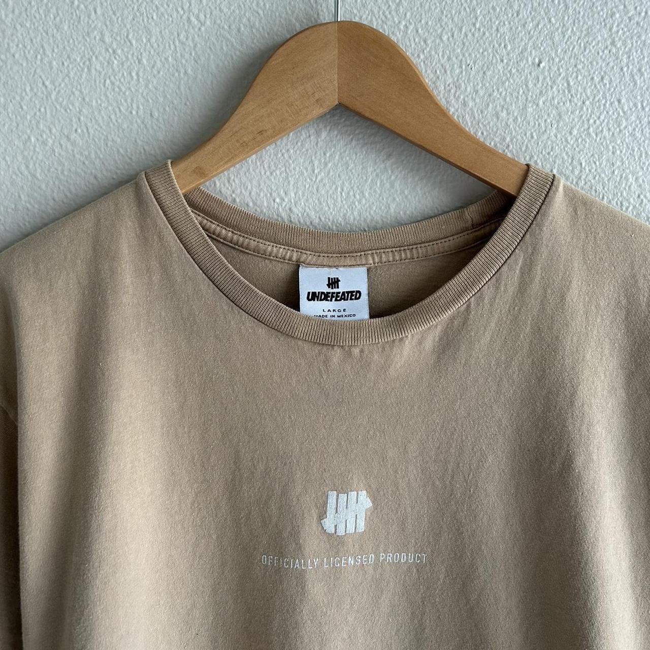 Undefeated Men's Tan and White T-shirt | Depop