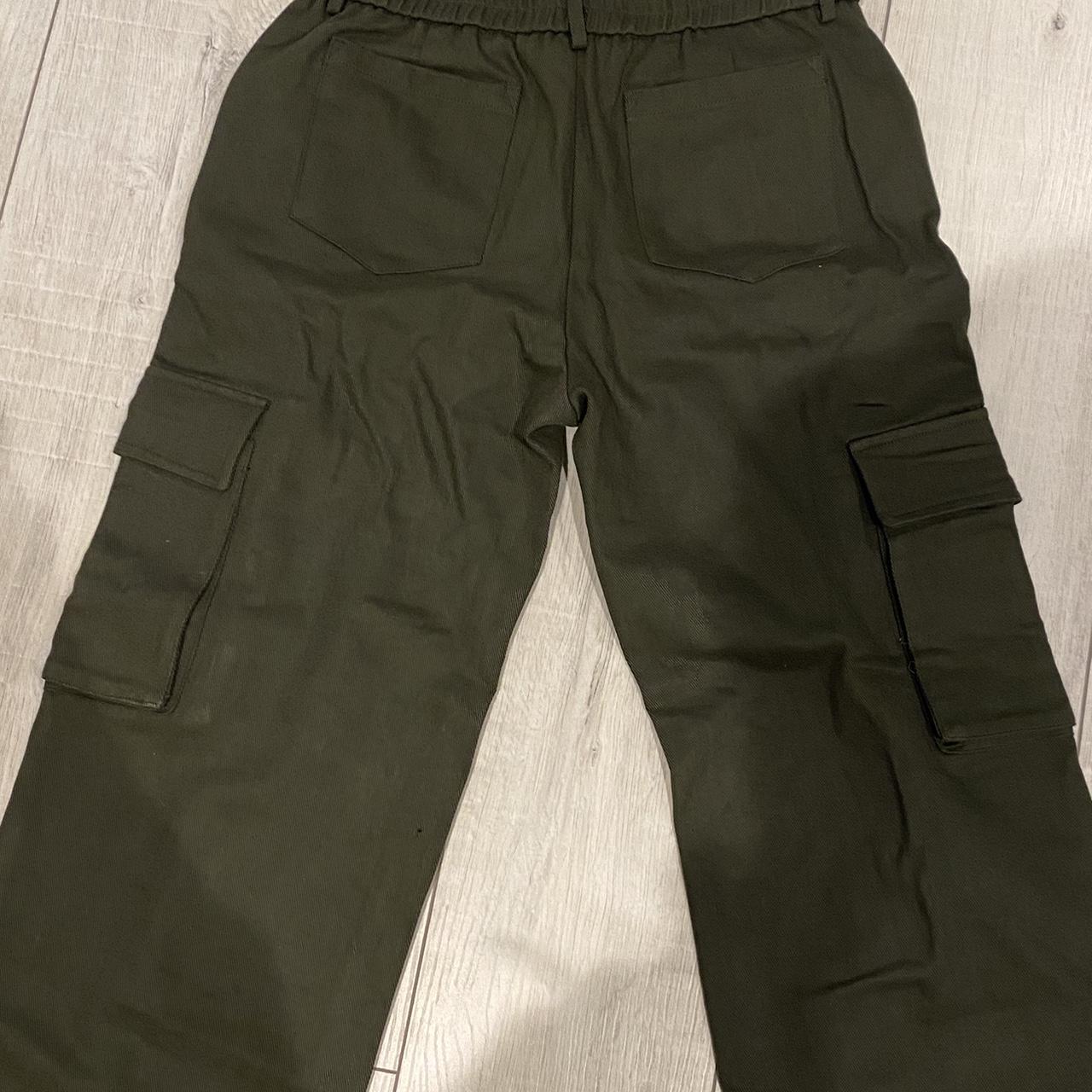 dark green cargo style trousers is a M would fit a... - Depop
