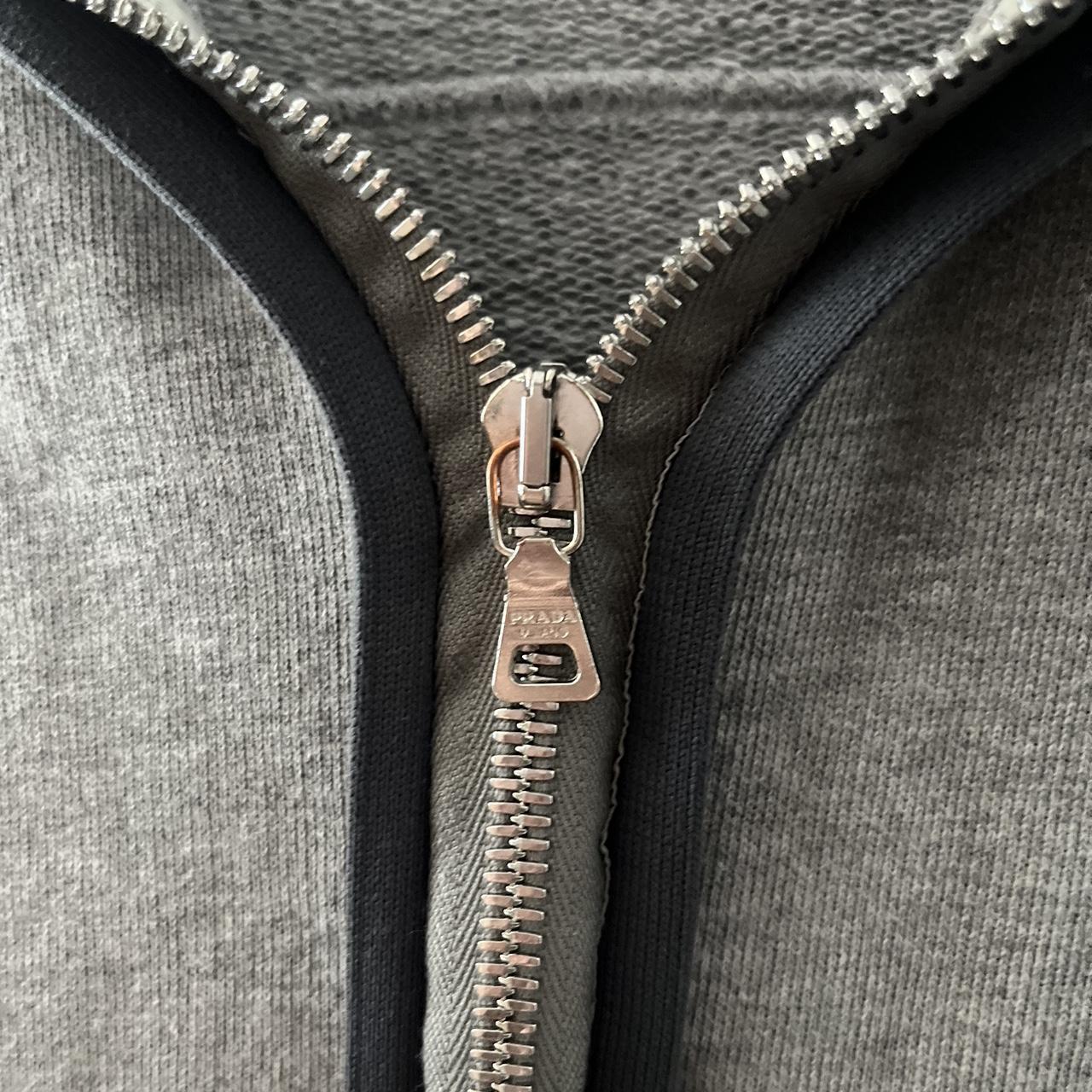 Prada Grey zip up hoodie Has a light stain on the... - Depop