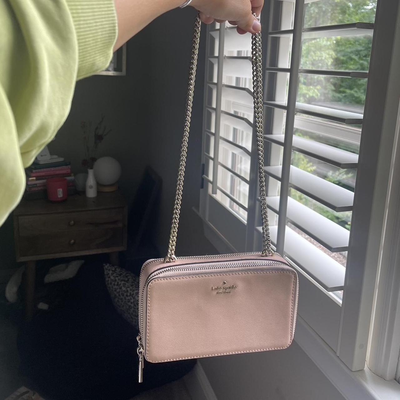 Pale pink Kate Spade purse with a chain strap that