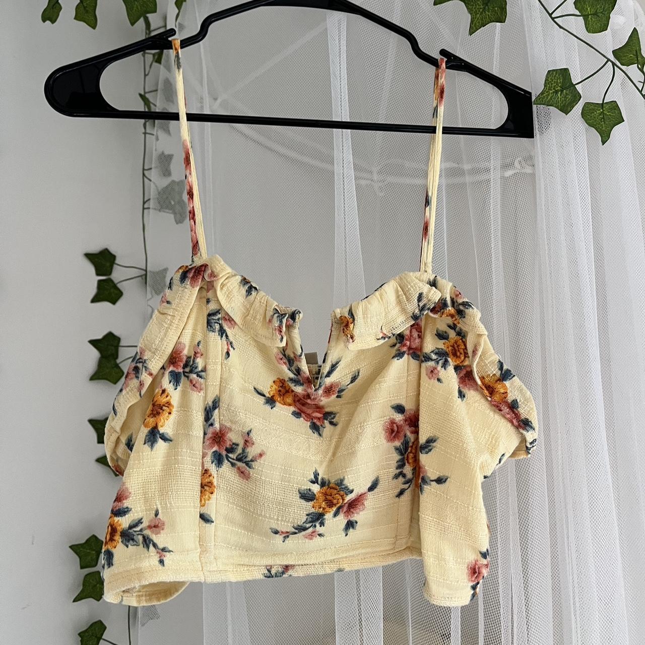yellow floral corset has boning that provides... Depop