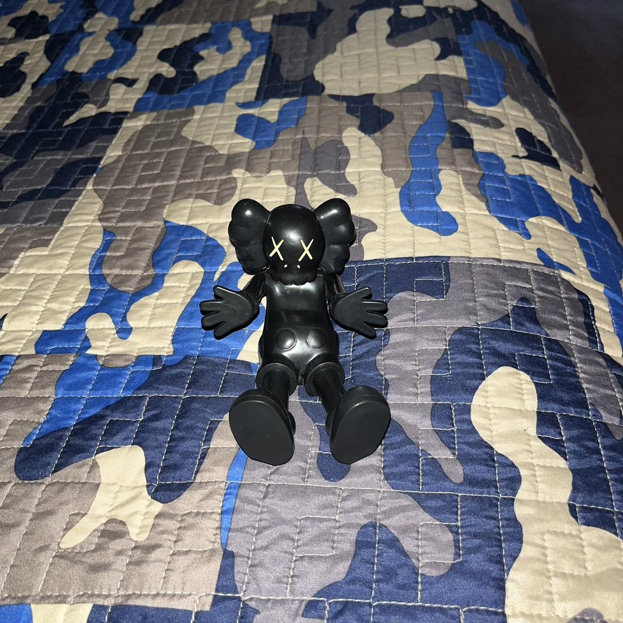 kaws black figure it lays down perfect condition... Depop