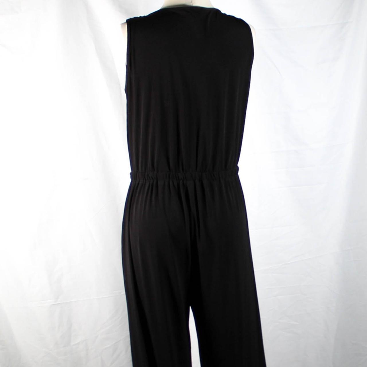 Need a classic black jumpsuit? This is a sleek black... - Depop