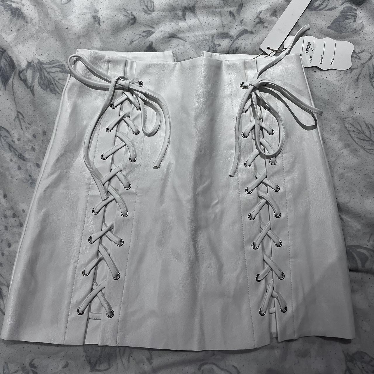 White mini skirt with tie front detailing. Never... - Depop