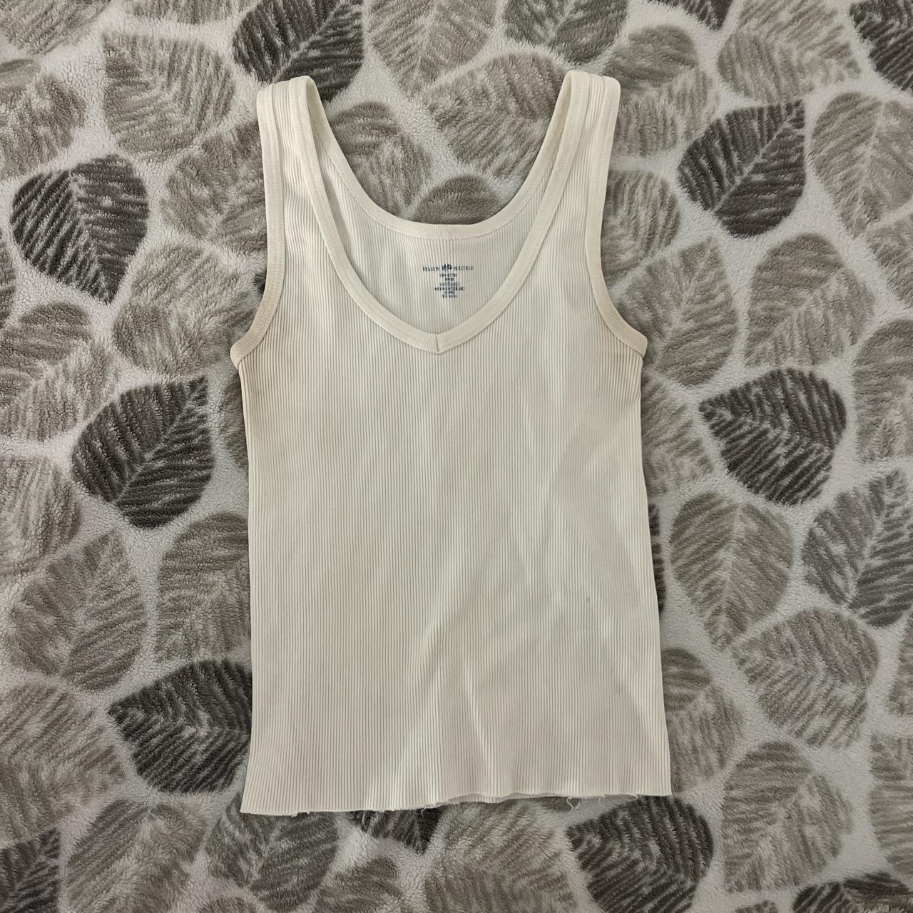 brandy melville white tank has some coloring on the... - Depop