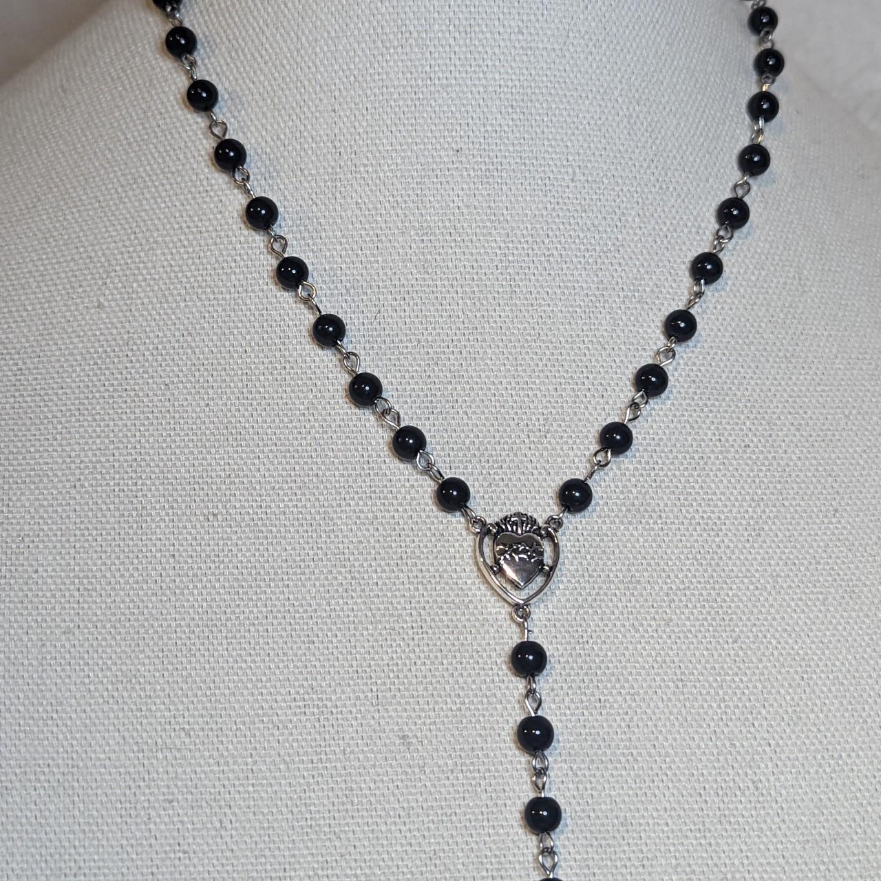 Rosary necklace with cross charm. Measures 18