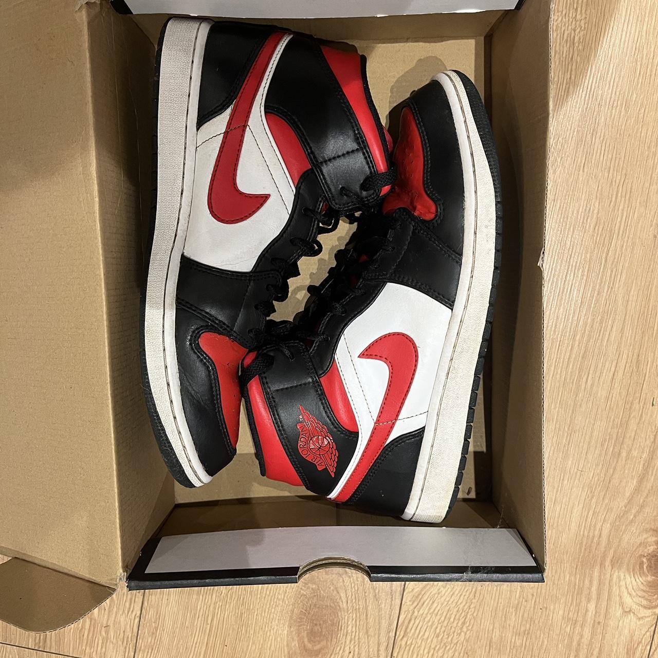 half black half red jordan ones