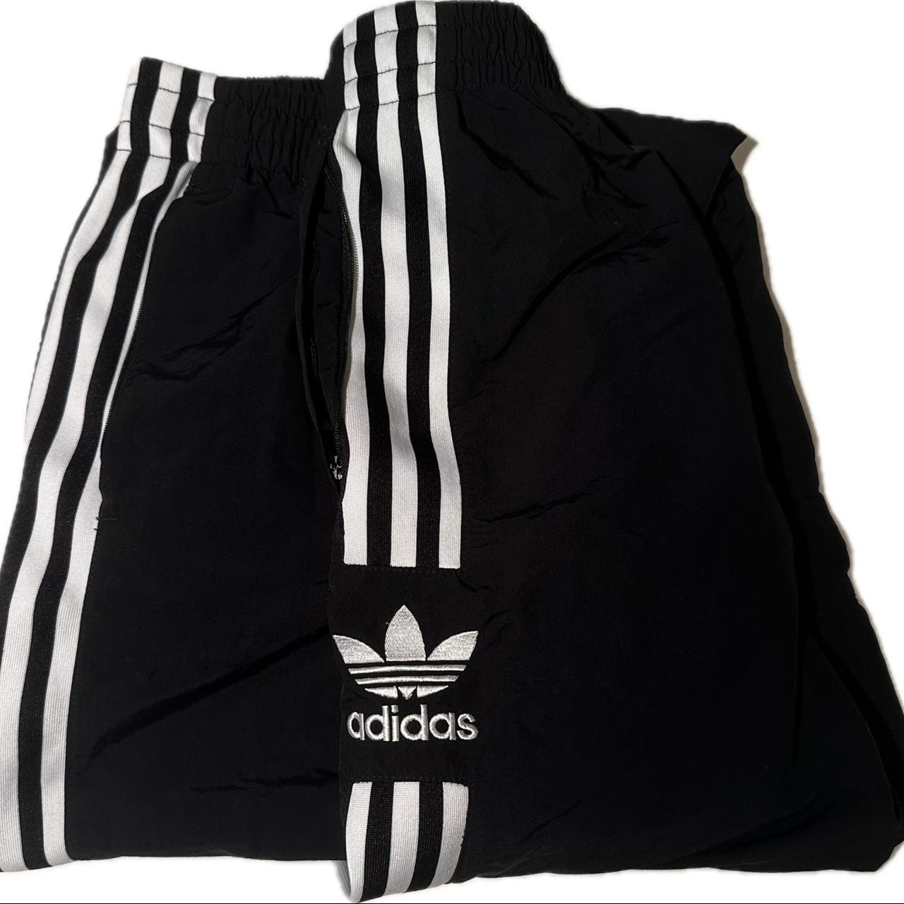 Black Adidas y2k track pants. Good condition wish no... Depop