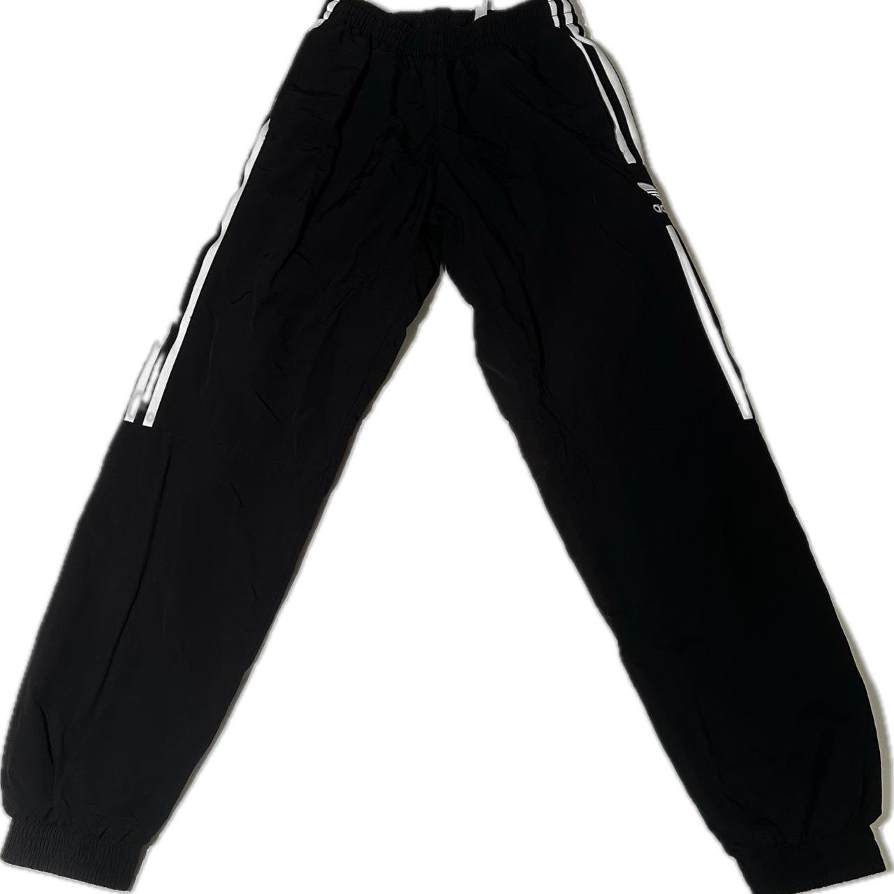 Black Adidas y2k track pants. Good condition wish no... Depop