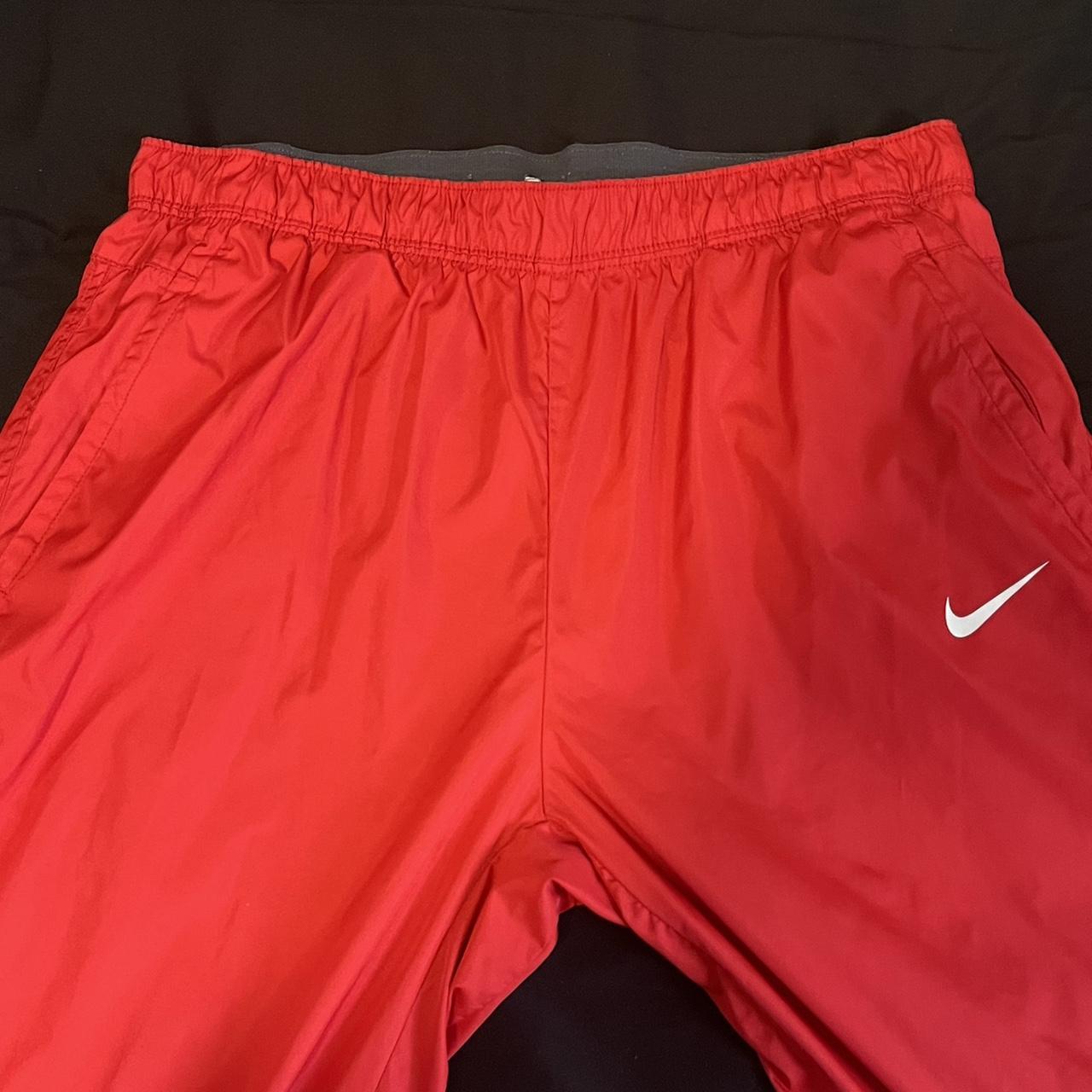 red nike track pants size medium - Depop