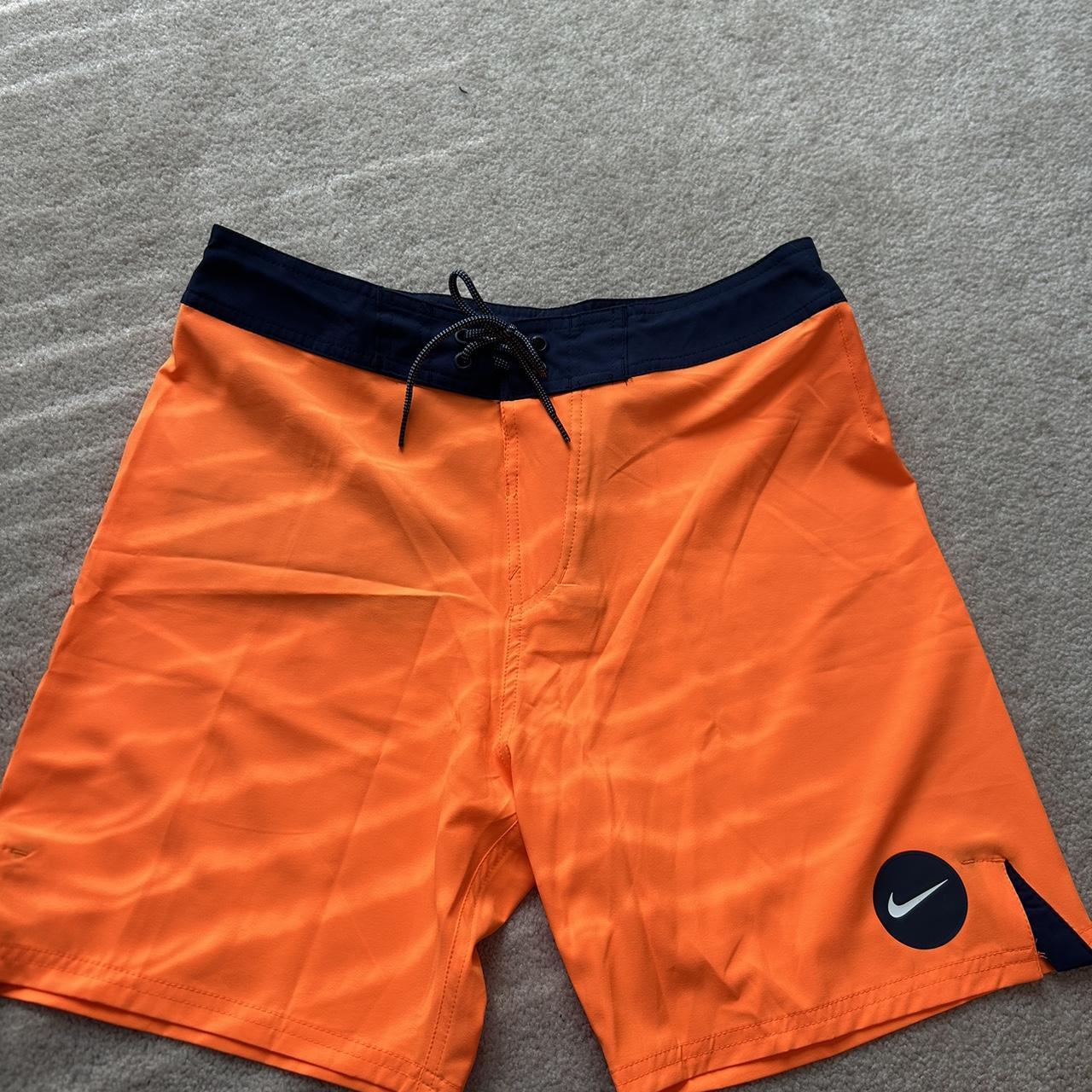 men s medium orange and navy Nike swim trunks never