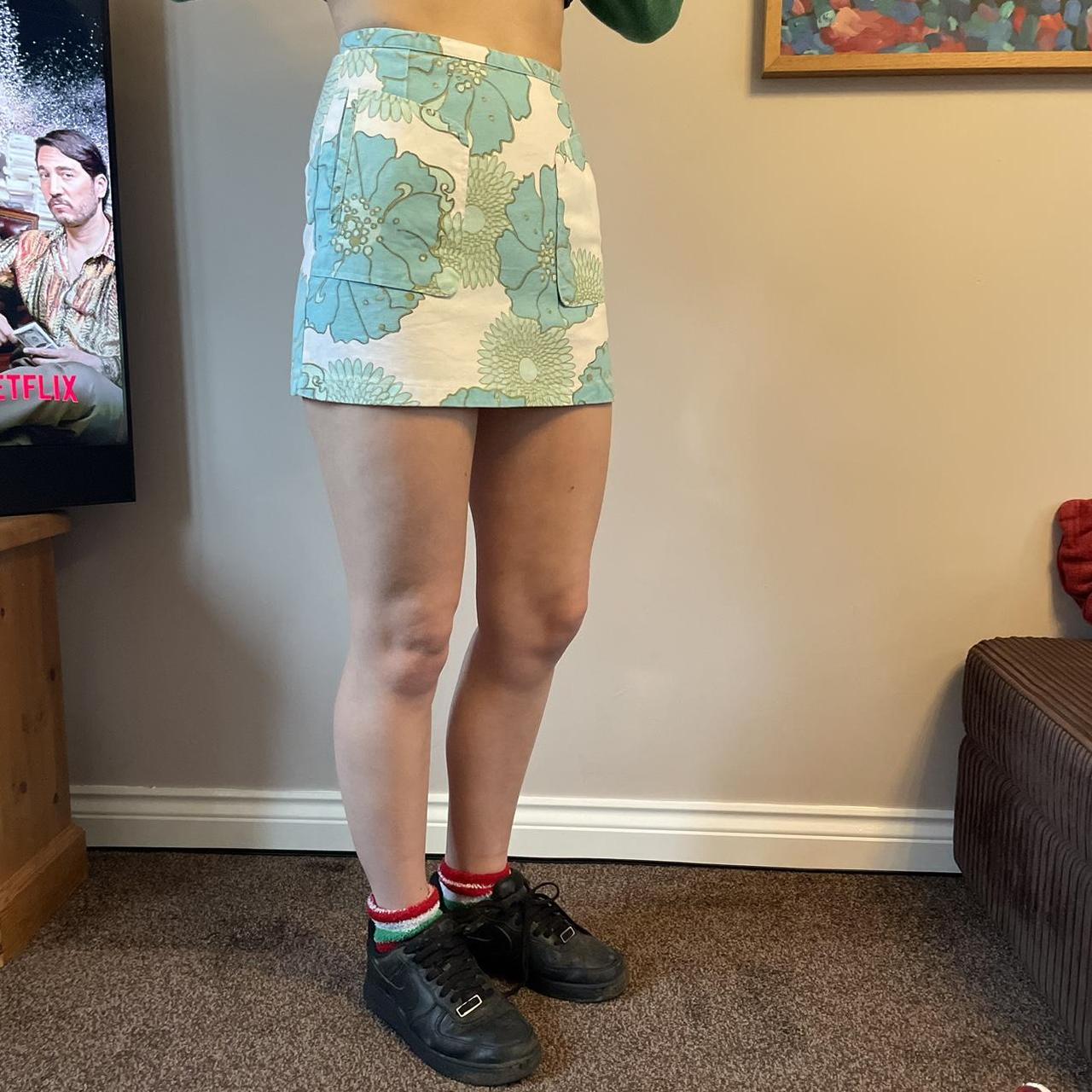 cream denim mini skirt with blue floral pattern... - Depop