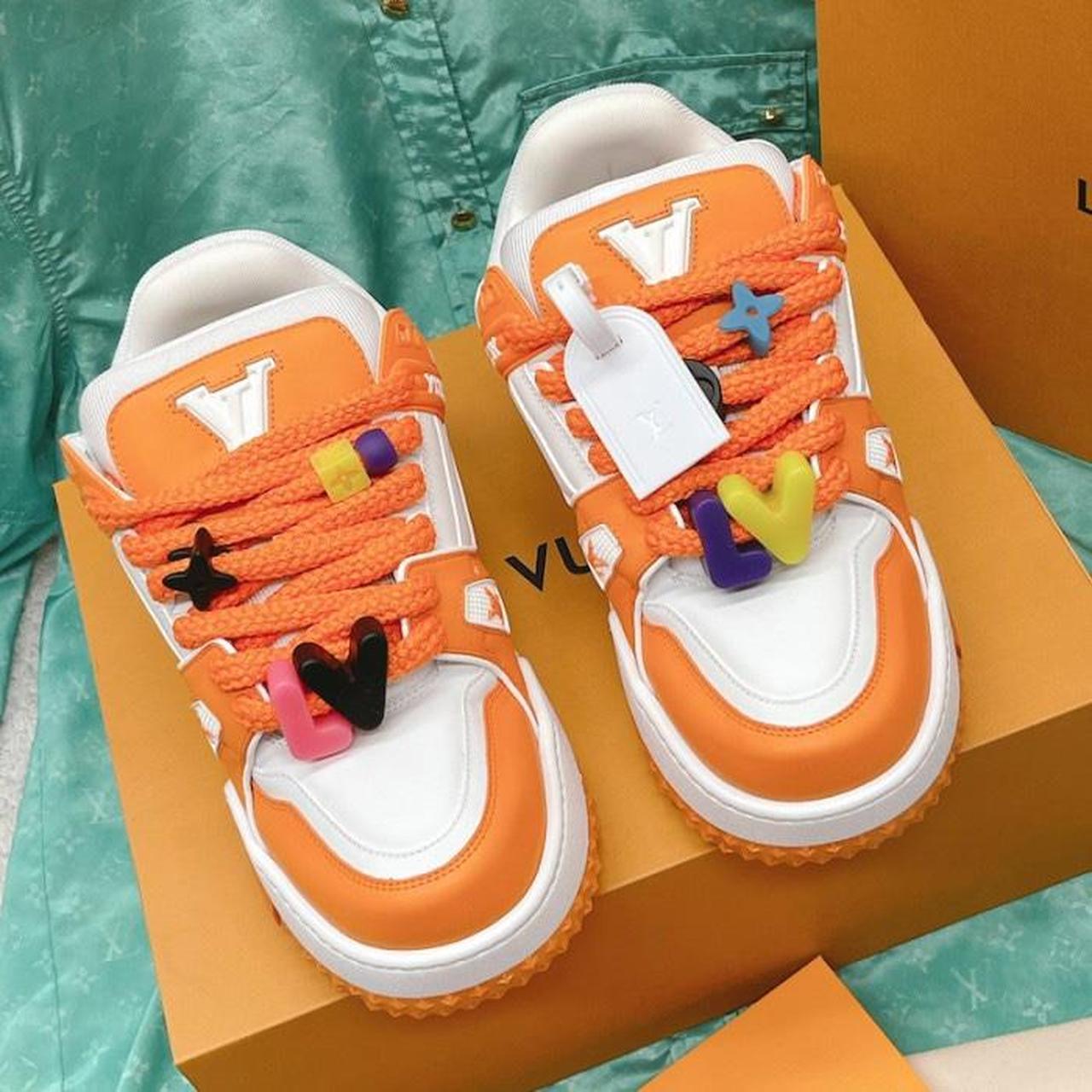 LOUIS VUITTON TRAINER MAXI LOW-TOP SNEAKERS IN WHITE AND ORANGE
